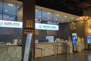 a hotel lobby with a reception counter and signs at Hotel Tour Incheon Airport Hotel & Suites in Incheon