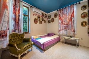a bedroom with a bed and a chair and a window at Central House for up to 20 Guests Entire Place in Sofia +35 photos