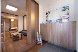 a room with a wooden cabinet and a table at お宿 春Haru in Muromoto