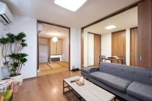 a living room with a couch and a table at お宿 春Haru in Muromoto