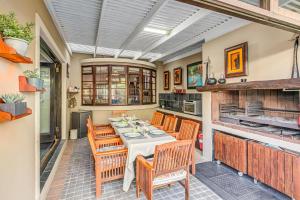 a kitchen and dining room with a table and chairs at Caledon 23 Guest House in George