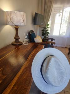 a large hat sitting on a wooden table in a living room at Bultpark Apartment in Potchefstroom
