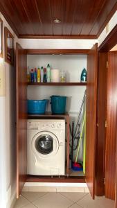 a kitchen with a washing machine in a cabinet at Monte Gordo T1 - Estrela do Mar in Monte Gordo