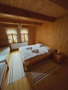 a bedroom with a bed in a wooden room at Drevenica MATAJKA in Kvačany +10 photos