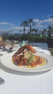 a pizza on a white plate on a table at Royal Park Green Spa in Orihuela Costa
