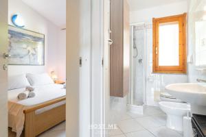 a bathroom with a bed and a sink and a toilet at Terrazza 12 - Free Wifi in Costa Rei