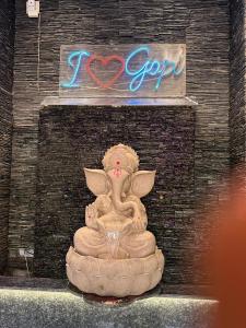 a statue of an angel sitting on a rock at Gopi Hotel And Restaurant in Sāgwāra
