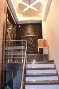 a set of stairs leading up to a building with a ceiling at Gopi Hotel And Restaurant in Sāgwāra
