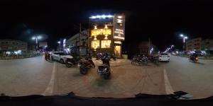 a group of motorcycles parked in front of a building at night at Gopi Hotel And Restaurant in Sāgwāra
