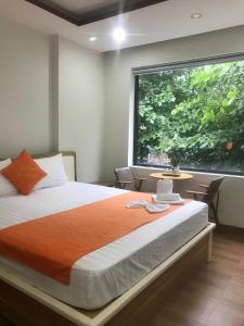 a bedroom with a bed and a large window at Bao Tran Homestay in Danang