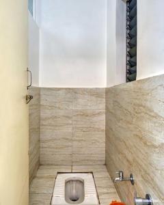a bathroom with a toilet in the floor at Hotel Rajpurush in Kolhapur