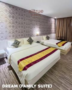 two beds in a hotel room with white and gold at Alltrue Sydney Hotel Batam Center in Batam Center +13 photos