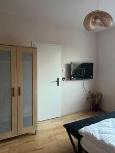 a bedroom with a bed and a tv on the wall at Ferienwohnung Fatlume No 3 in Bad Honnef am Rhein
