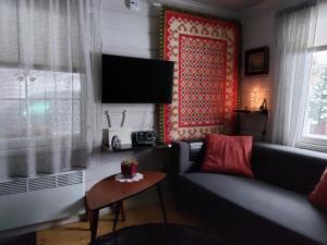 a living room with a couch and a table at Villa Bear's in Rovaniemi