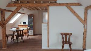 a kitchen and dining room with wooden beams and a table and chairs at Large Private Room Near Colmar Center with Free Public Parking in Colmar +10 photos