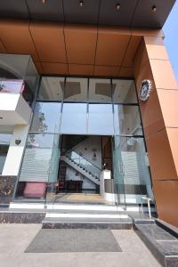 an external view of a building with glass windows at Hotel Amar Singh Palace in Agra