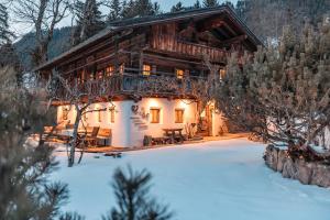 a log cabin in the winter with snow at Hunters Lodge Chalet Superior in Alpbach