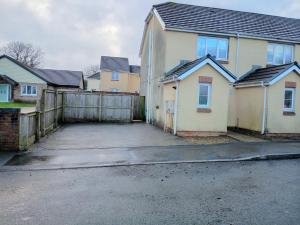 an empty parking lot in front of a house at Noglas in Ammanford