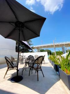 a table and chairs with an umbrella on a patio at Casa Zapopan Hotel in Guadalajara