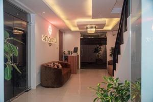 a lobby with a couch and a chair in a building at Sky Garden Kandy in Kandy