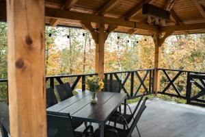 a wooden table and chairs on a deck at Countryside cottage with mountain view in Lukovica pri Domžalah