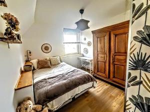 a bedroom with a bed and a dresser and a window at Écrin Ostwald 2 private suites Free parking in Ostwald
