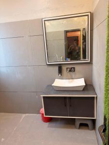 a bathroom with a sink and a mirror at Govindam Palace in Govardhan