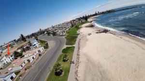 an aerial view of the beach and the ocean at Sleep to the Sound of Waves - Full Private Apartment in Swakopmund