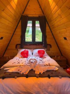 a bed in a wooden room with a window at AĞARaN SUİT BUNGALOV in Rize