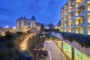 a view of a building and a street at night at Vila Foz Hotel & SPA in Porto