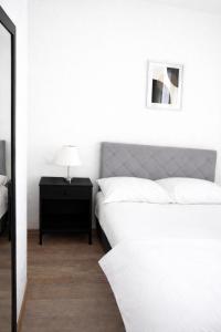 a bedroom with a bed and a table with a lamp at Apartmani Sun & Moon in Žepče +17 photos