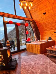 a room with a tub and a large window at AĞARaN SUİT BUNGALOV in Rize