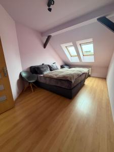 a bedroom with a bed and a wooden floor at Pilsen flat in Pilsen