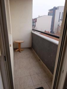 a small room with a small table on a balcony at Apartman Balkan in Bijeljina