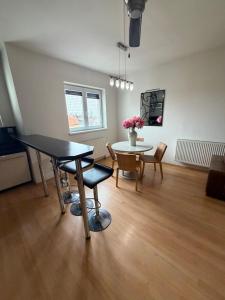 a living room with a table and a table and chairs at Pilsen flat in Pilsen