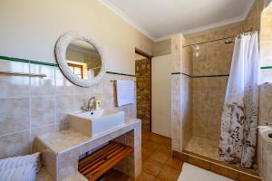 a bathroom with a sink and a shower at Ramabanta Trading Post in Setleketseng +76 photos