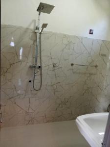 a bathroom with a shower and a sink at The nest haputale in Haputalegama