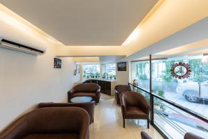 a living room with chairs and a waiting room at Hotel JK Regency, Mumbai International in Mumbai