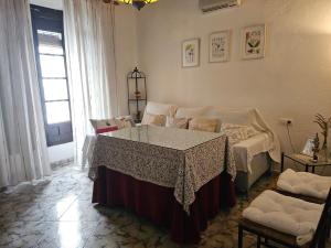 a living room with a table in the middle of a room at Casa de La Abuela Pepi in Aracena