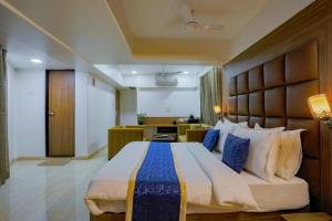 a bedroom with a large bed in a room at Hotel JK Regency, Mumbai International in Mumbai