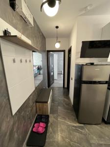 a kitchen with a counter with pink shoes on a bench at Ideal House Rent in Petroşani
