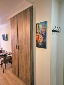 a door in a room with a painting on the wall at Bakuriani Plaza A block N109 in Bakuriani