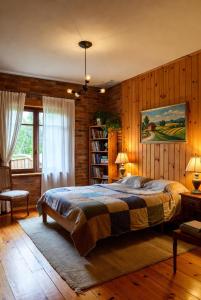 a bedroom with a large bed and a book shelf at PLand Agrotourism in Bharatpur