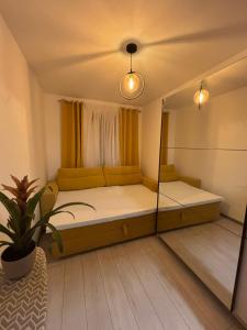 a room with a bed and a large mirror at Stan na dan in Pljevlja