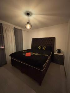 a bedroom with a bed with a black comforter at Stan na dan in Pljevlja
