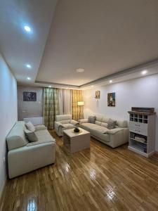 a living room with two couches and a table at Stan na dan in Pljevlja