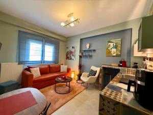 a living room with a couch and a table at Casa dell'Arte & Quiet Area & Free Parking in Volos