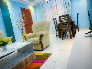 a living room with two chairs and a table at Résidence TB in Douala
