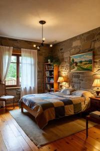 a bedroom with a large bed and a stone wall at PLand Agrotourism in Bharatpur