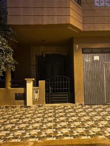a front door of a building with a checkered floor at Maison in Berkane